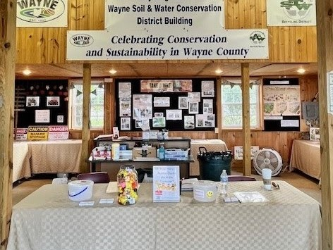 Exhibit for Wayne County's conservation and sustainability with posters, brochures, and a display table.