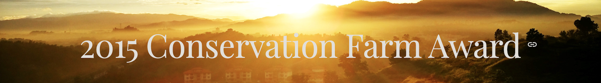 Text "2015 Conservation Farm Award" over a scenic sunrise landscape.