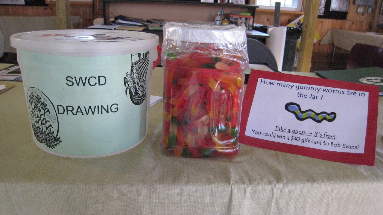 Jar of gummy worms, SWCD drawing bucket, and sign for guessing game to win a $30 gift card to Bob Evans.