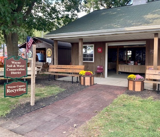 Wayne Soil & Water Conservation District and Wayne County Recycling building with signs, benches, and flowers in front.