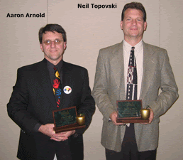 Two men holding awards, wearing suits, with their names labeled above them.