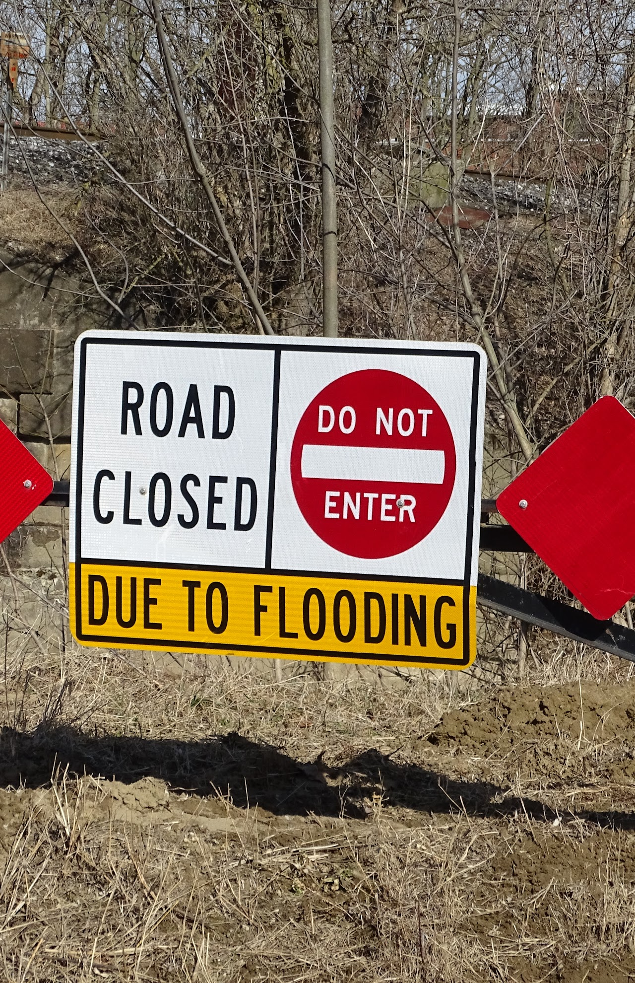 Sign: "Road Closed, Do Not Enter, Due to Flooding."