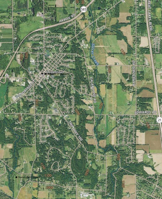 Aerial view of Doylestown, showing roads, buildings, and surrounding fields.