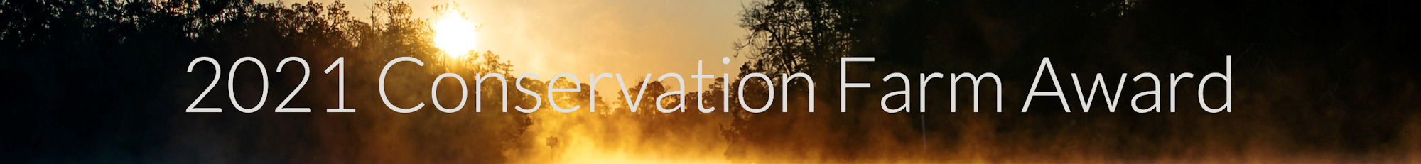 "2021 Conservation Farm Award" text over a sunrise or sunset with trees in the background.