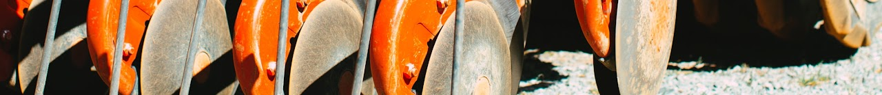 Close-up of rusted industrial blades or disks arranged in a row.