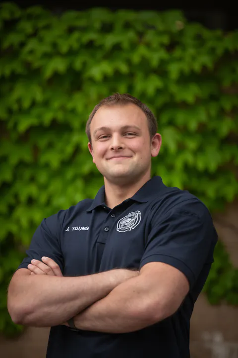 Engineer Joe Young smiling with arms crossed
