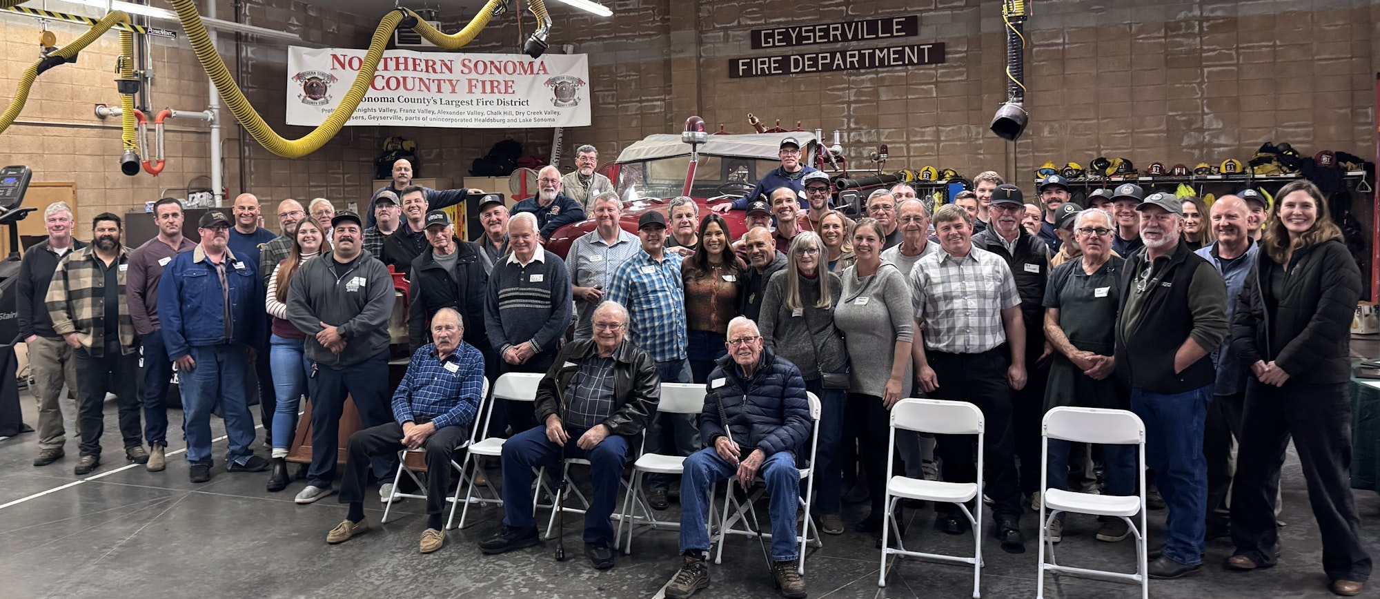A large group of people gathered for an event at the Geyserville Fire Department, showcasing camaraderie and community spirit.