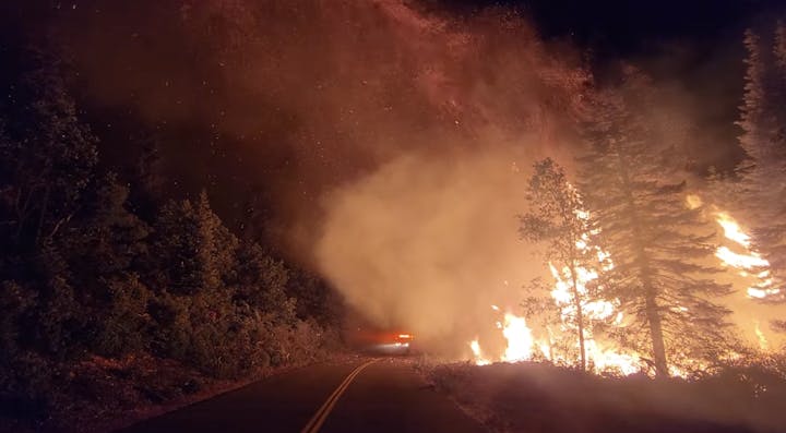 May contain: fire, road, and forest fire