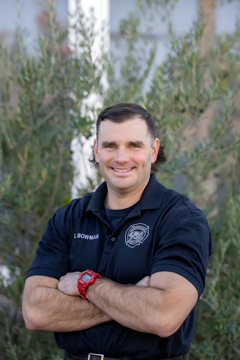 Engineer Tyler Bowman smiling with arms crossed