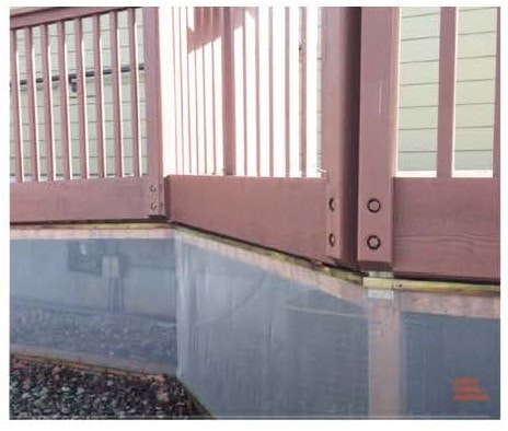 A misaligned fence gate not properly closing at the bottom.