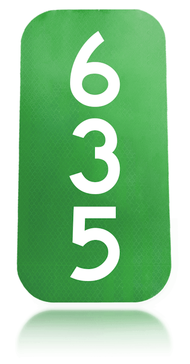 A reflective address sign displaying the number 635.