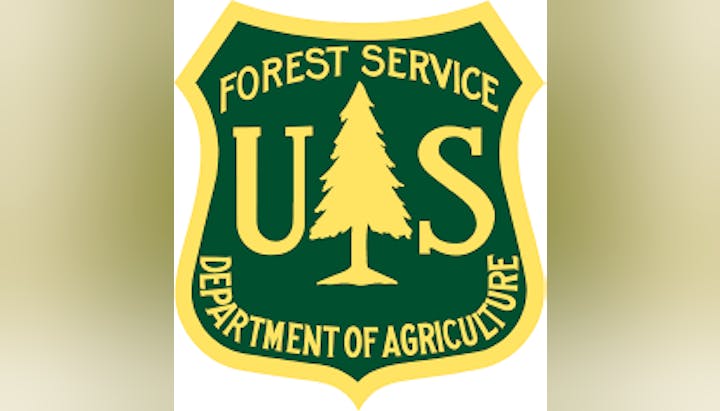 U.S. Forest Service emblem with a tree, part of the Department of Agriculture.