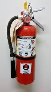 A red fire extinguisher with instructions, mounted on a wall.