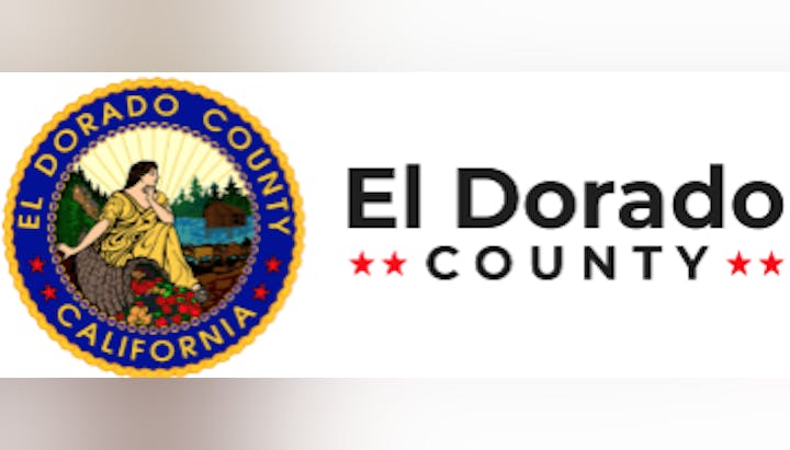 El Dorado County logo with a woman in a yellow dress, mountains, and water, next to the name "El Dorado County."