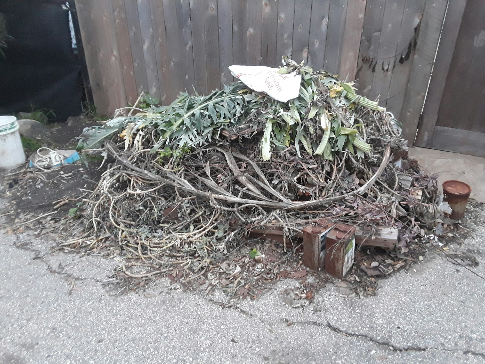 A pile of green waste on top of a wooden pallet.