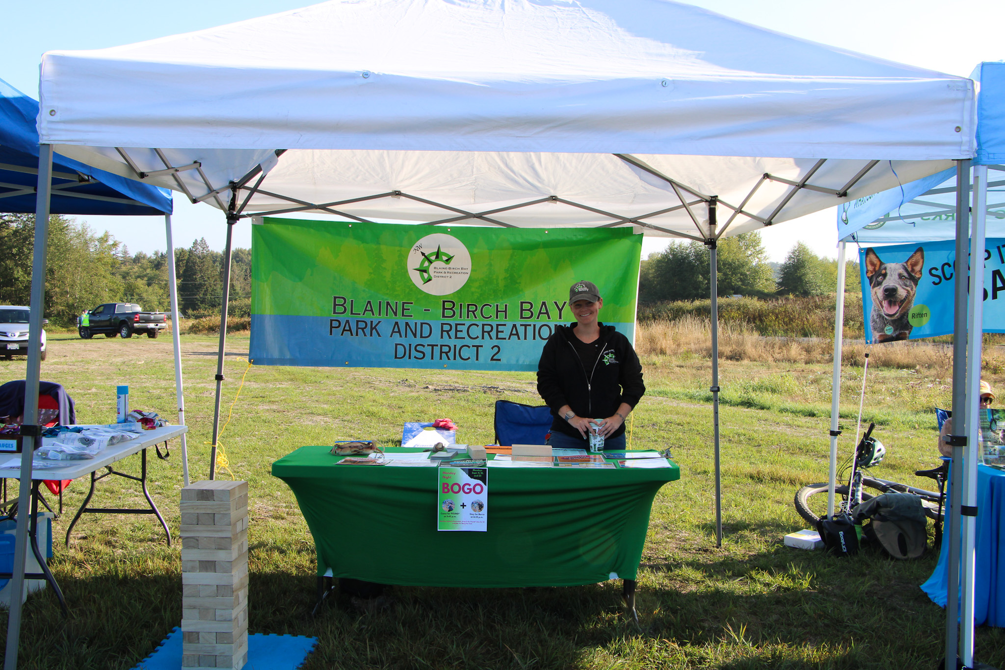 Outdoor booth for Blaine-Birch Bay Park and Recreation District, featuring informational materials and promotional offers.