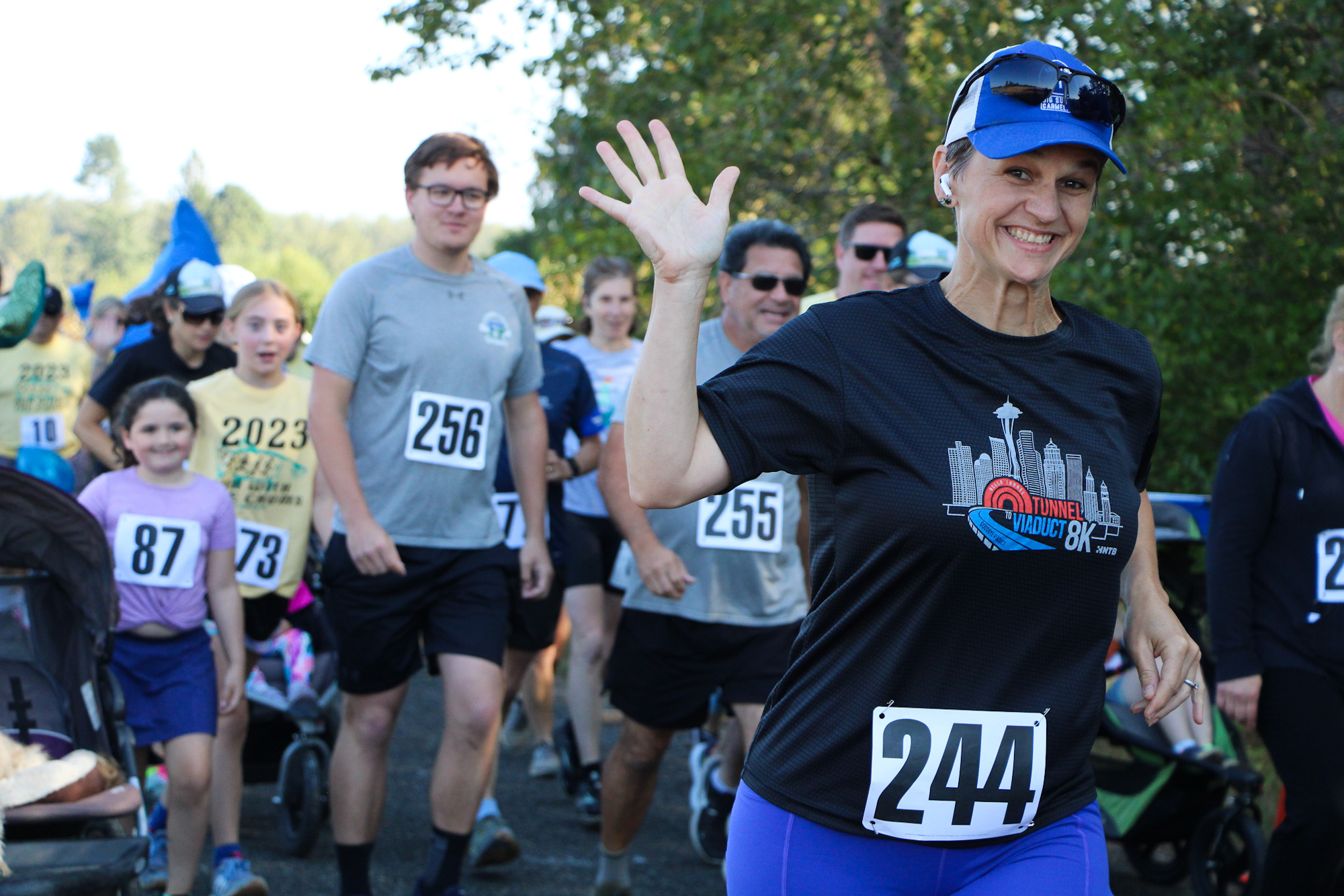 People participating in a race, wearing numbered bibs.