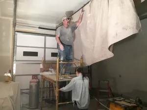 Photo of construction workers working in a garage