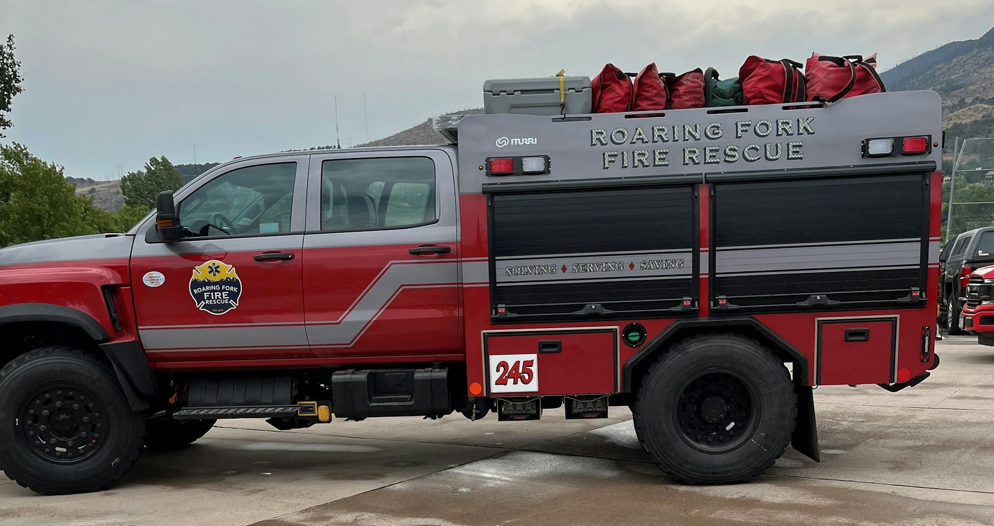 The image shows a Roaring Fork Fire Rescue truck, marked with their emblem and equipped for emergency response.