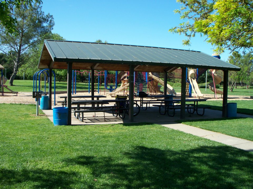 May contain: grass, plant, park, outdoors, nature, shelter, building, architecture, play area, outdoor play area, and lawn