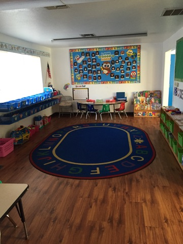 May contain: chair, furniture, home decor, rug, box, school, building, architecture, desk, table, flag, classroom, room, and indoors