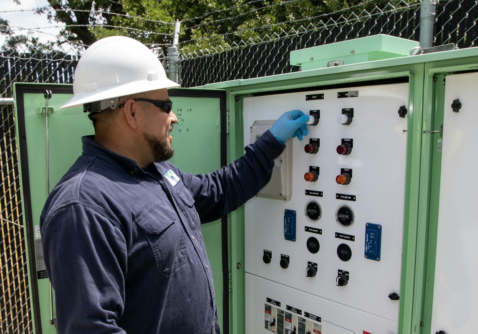 May contain: clothing, hardhat, helmet, person, worker, glove, accessories, glasses, electrical device, and switch