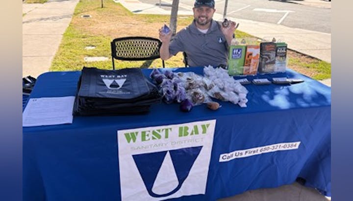 May contain: tablecloth, adult, male, man, person, clothing, t-shirt, chair, furniture, grass, plant, table, and desk