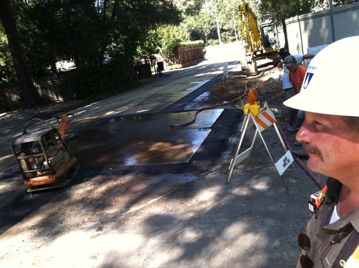 May contain: clothing, hardhat, helmet, person, path, footwear, shoe, hat, car, transportation, vehicle, and worker