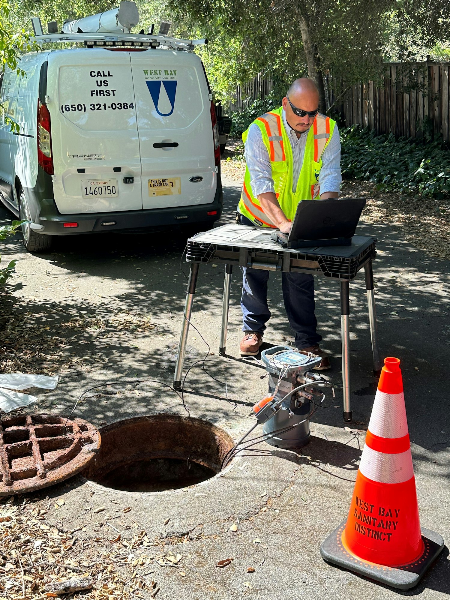 May contain: person, worker, adult, male, man, computer, electronics, laptop, pc, clothing, footwear, shoe, hole, accessories, glasses, car, transportation, vehicle, hardhat, and helmet