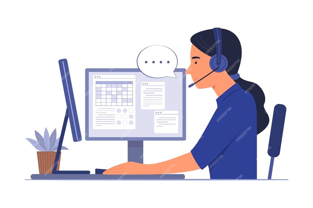 Person at a computer, wearing a headset, with a plant nearby, appearing to work or chat.