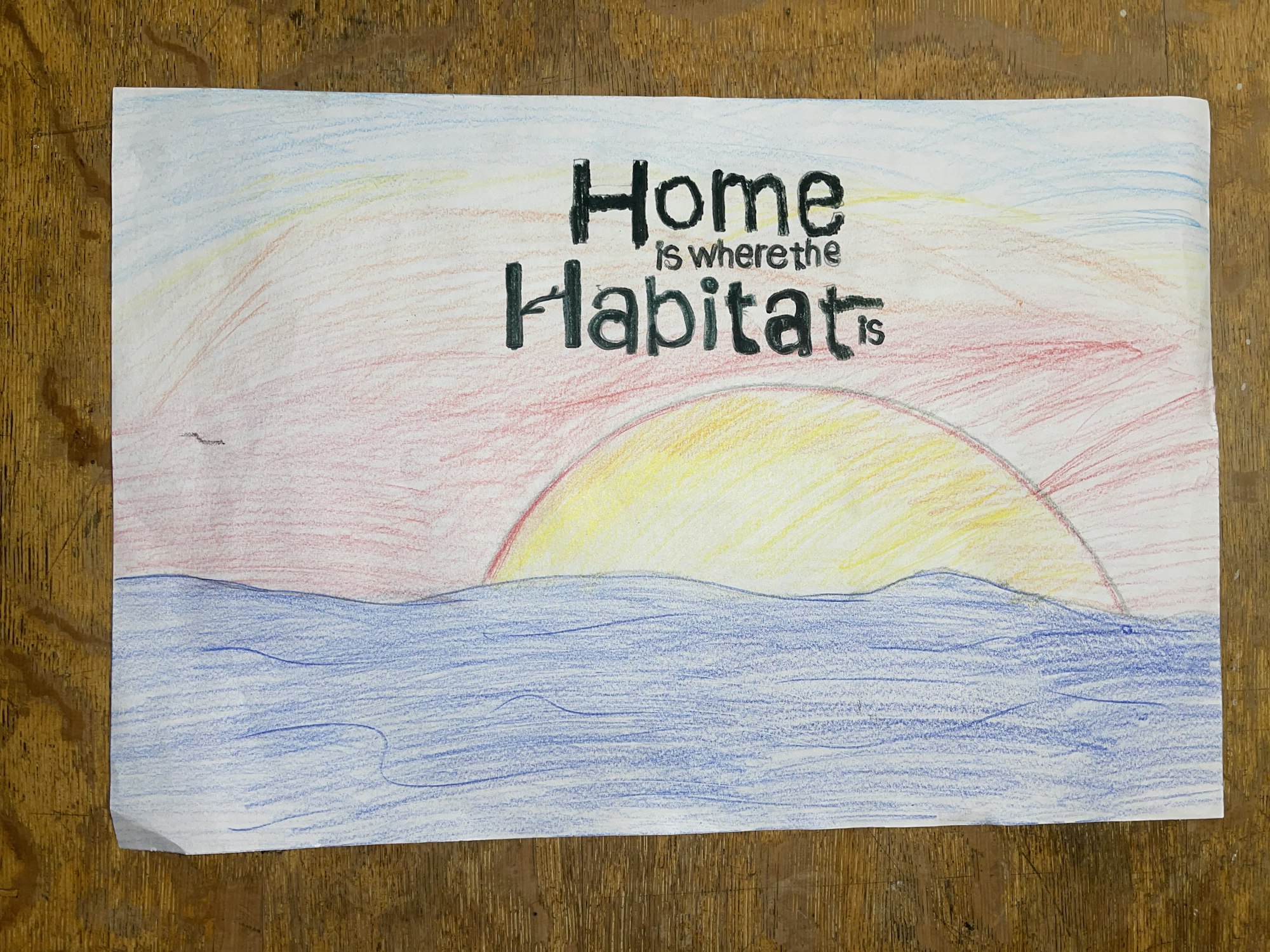 A colorful drawing featuring a sunset with the phrase "home is where the heart is" stylized in bold letters.