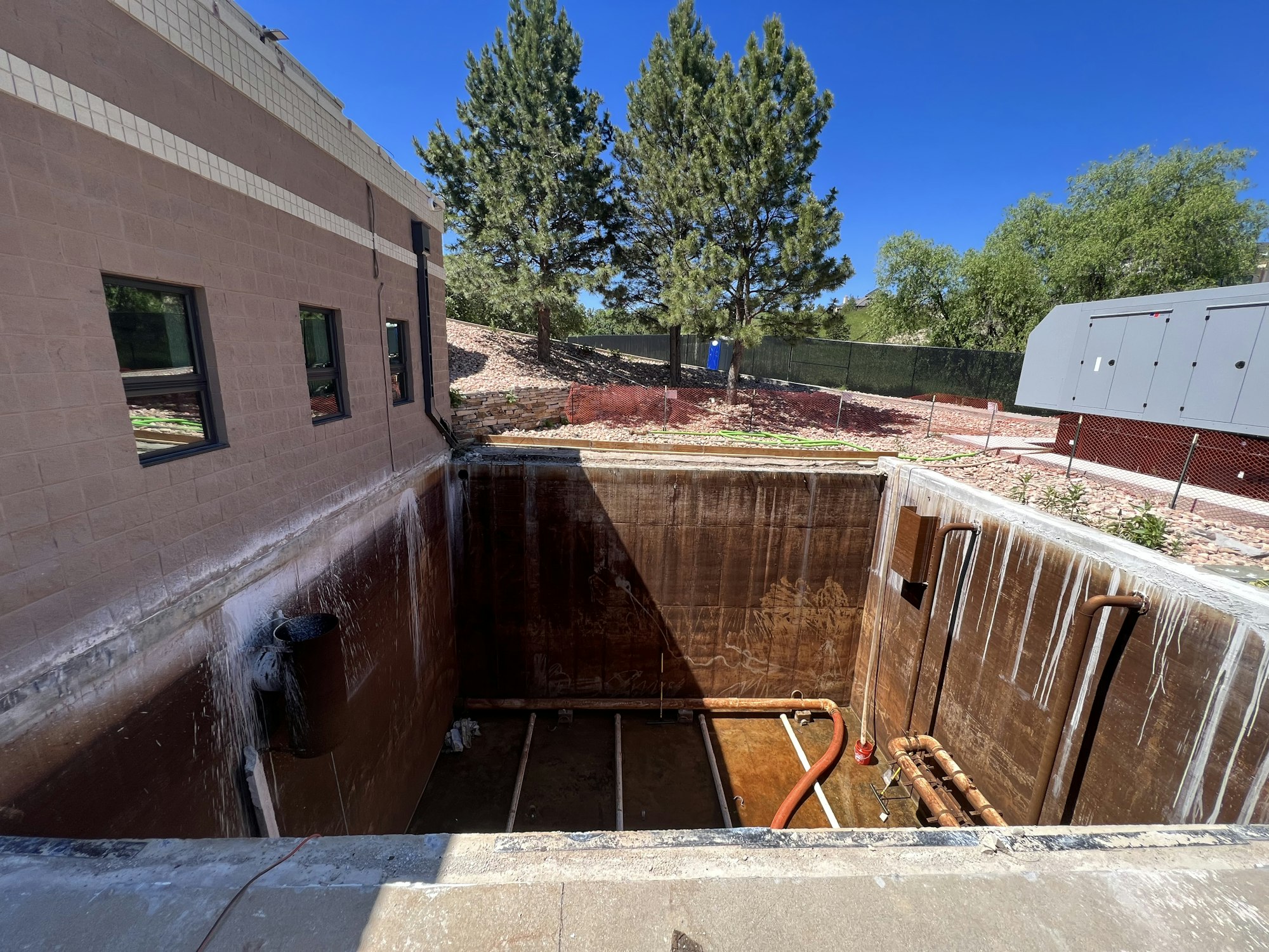 An empty, rectangular concrete pit that will become the backwash reclaim tank.