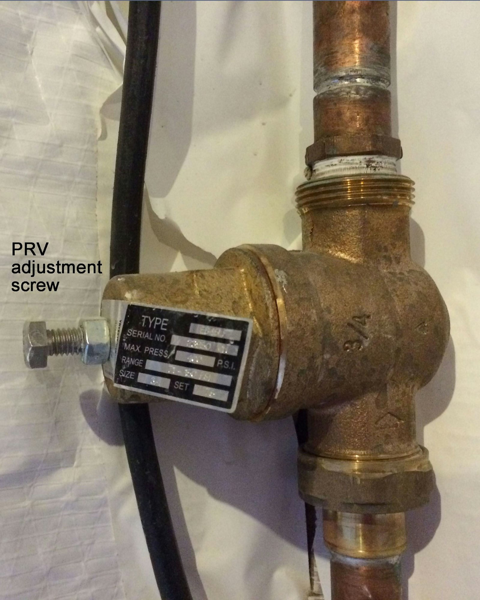 A PRV adjustment screw against a white backdrop