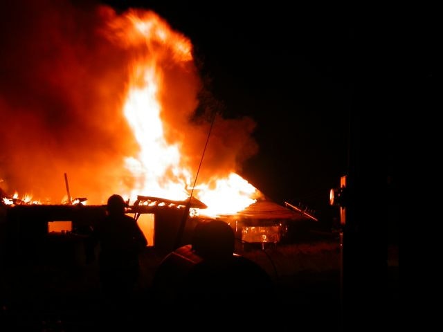 May contain: person, human, fire, bonfire, and flame