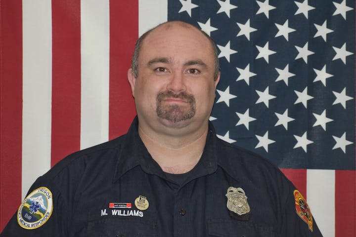 May contain: captain, person, officer, police officer, man, adult, male, face, and head