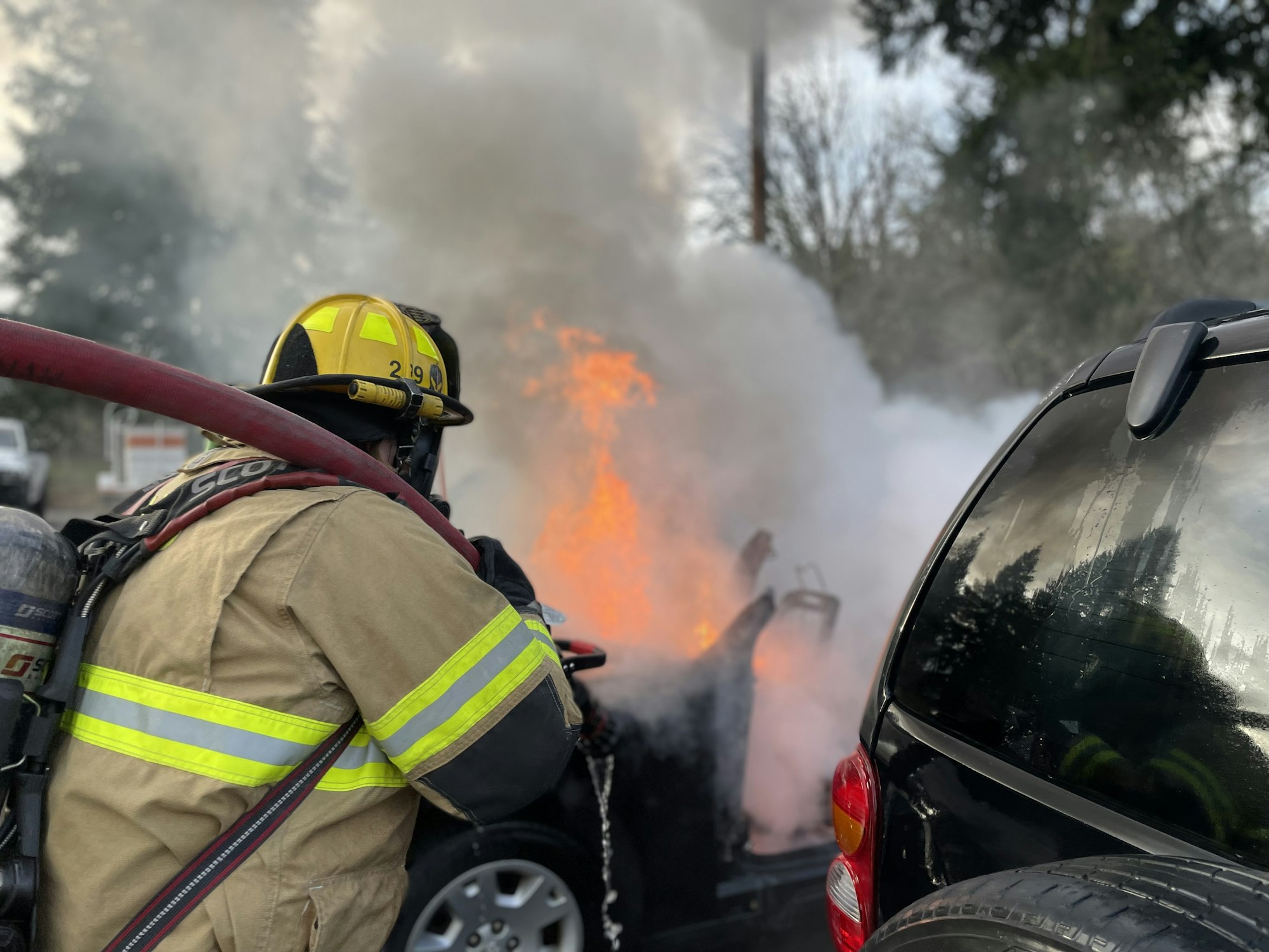 May contain: helmet, person, car, vehicle, transportation, glove, clothing, fire, pickup truck, and truck