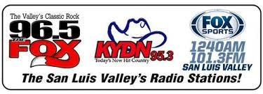 The image features logos and names of radio stations in the San Luis Valley: 96.5 FOX, KYDN 95.3, and FOX Sports.