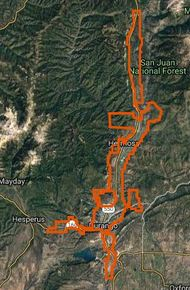 The image shows a map with an orange route outlined, possibly indicating a trail or path in a mountainous area.