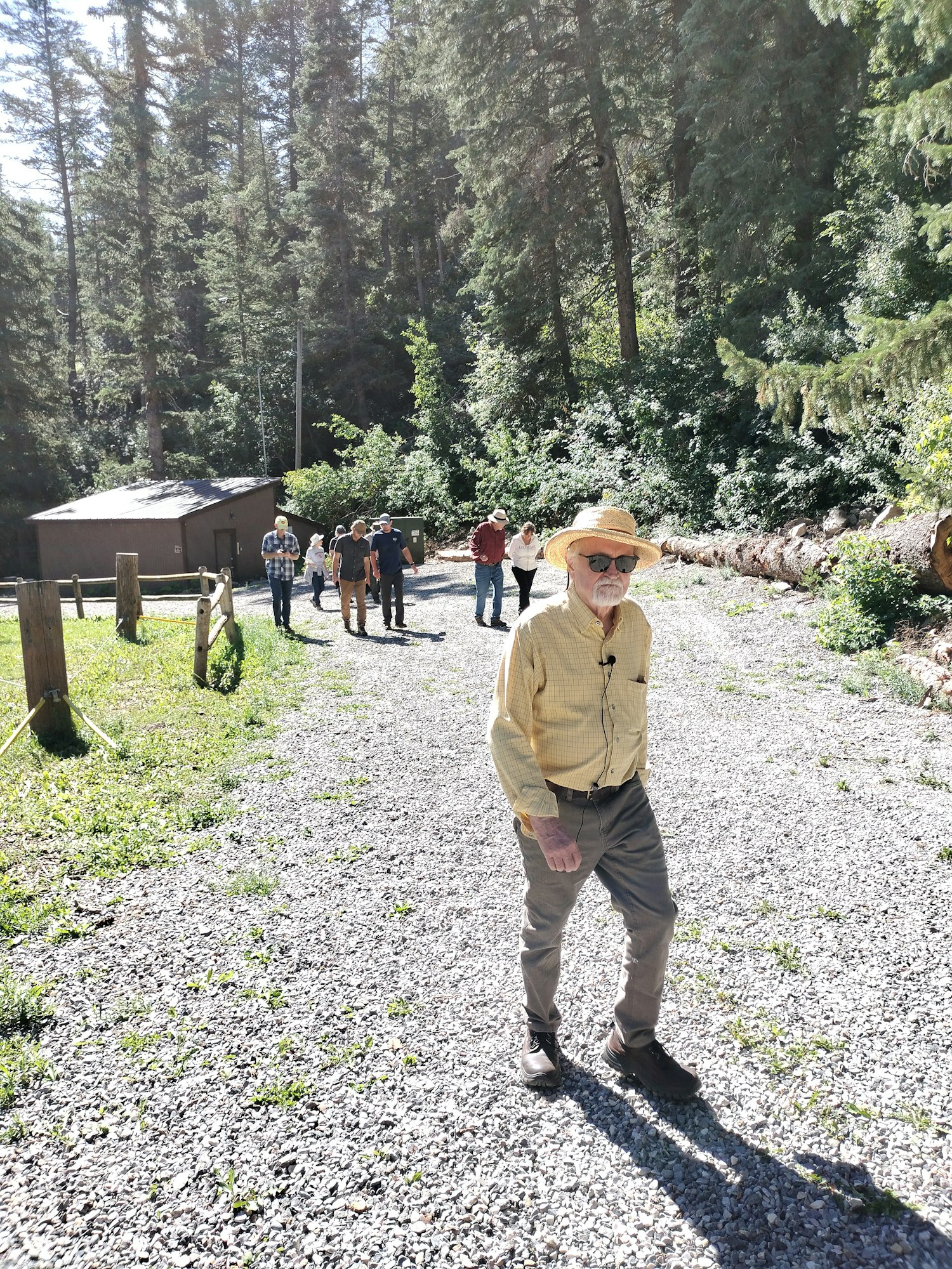 May contain: grove, land, nature, outdoors, plant, tree, vegetation, woodland, wilderness, person, walking, face, head, photography, portrait, clothing, hat, gravel, road, adventure, hiking, leisure activities, rainforest, grass, park, path, jungle, trail, adult, male, man, pants, fir, coat, and conifer