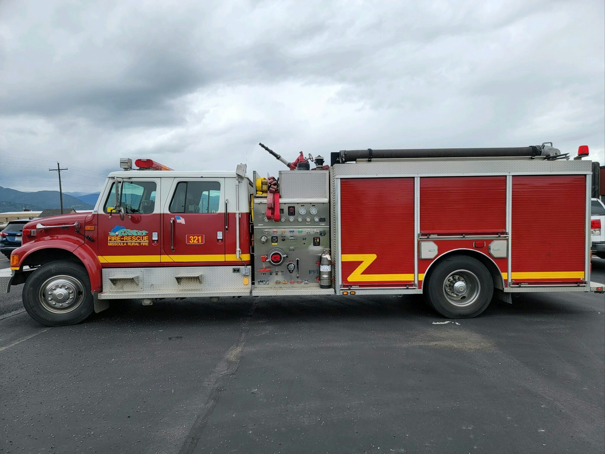 A red fire rescue truck from Missoula Rural Fire, with various equipment visible on the side.