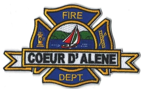 Patch with "Coeur d'Alene Fire Dept." features a sailboat, lighthouse, and a fire hydrant.