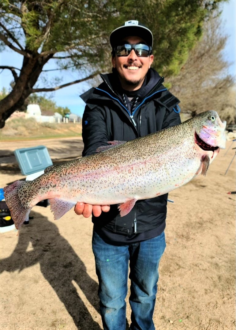 May contain: portrait, person, photography, head, face, fish, sea life, animal, trout, pants, clothing, jeans, sunglasses, accessories, jacket, and coat