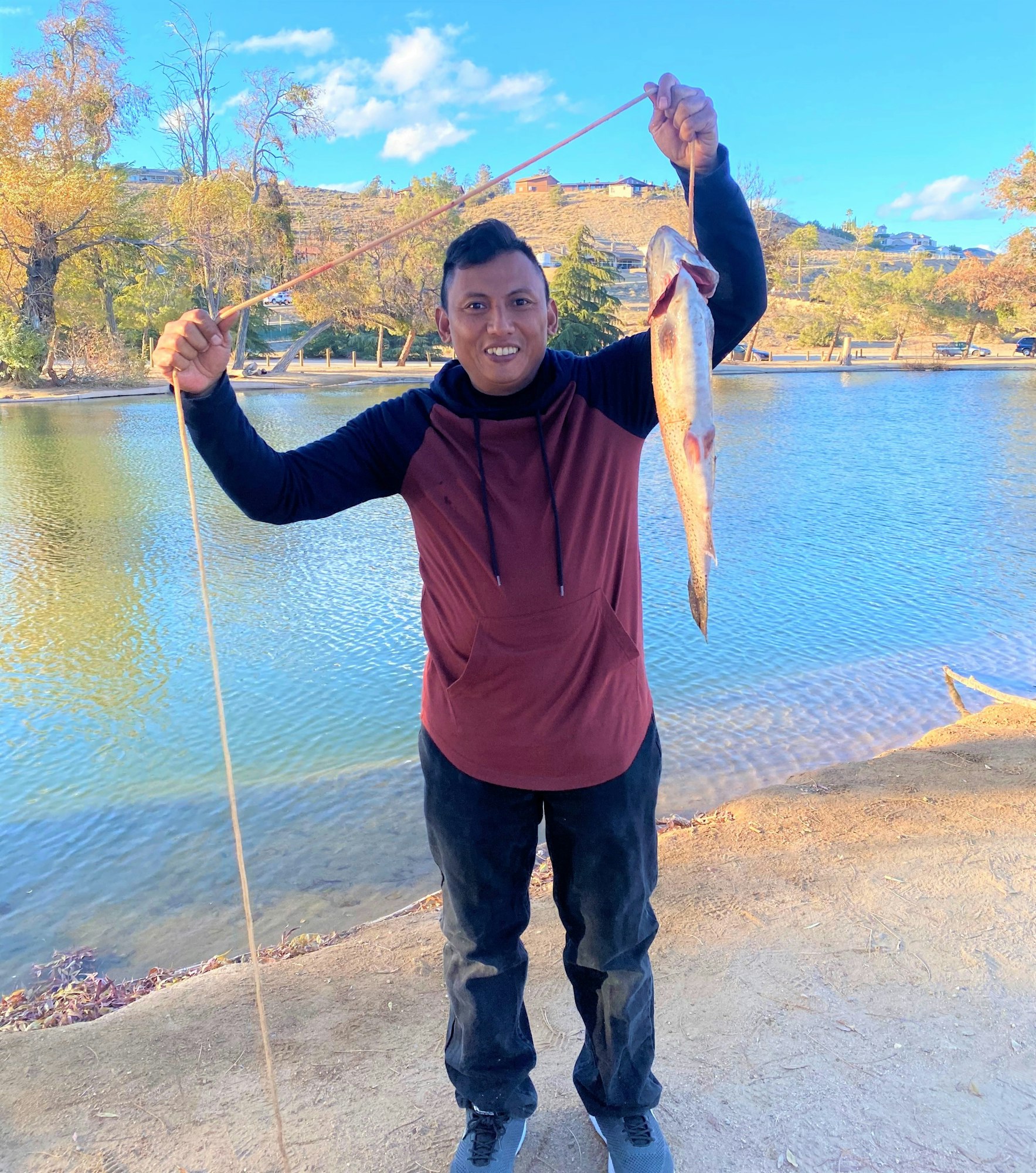 May contain: portrait, photography, person, head, face, fishing, outdoors, water, leisure activities, pants, clothing, scenery, nature, lake, waterfront, fish, sea life, and animal