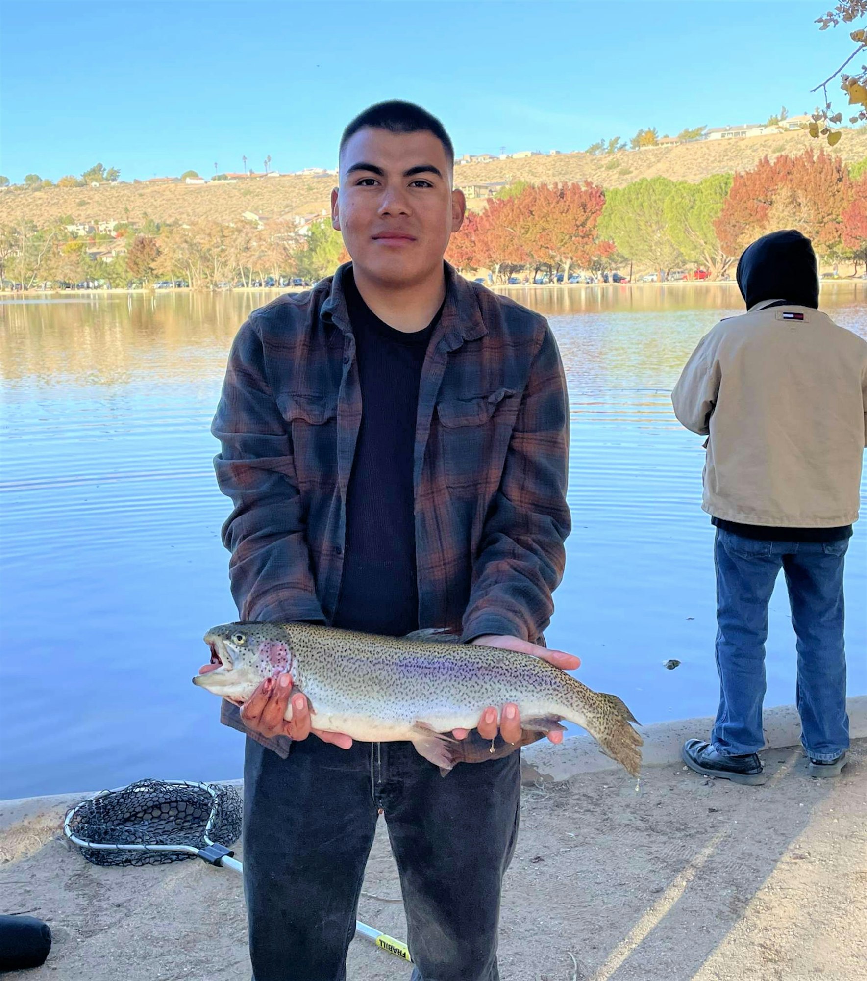 May contain: trout, fish, sea life, animal, hoodie, sweatshirt, sweater, knitwear, clothing, outdoors, portrait, person, photography, head, face, and water