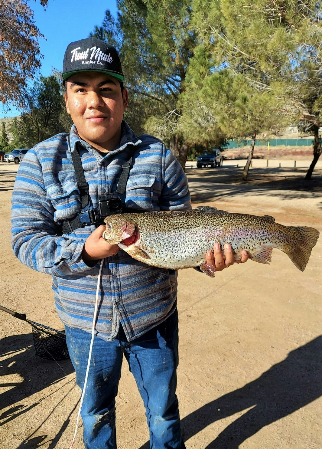 May contain: trout, animal, fish, person, and human