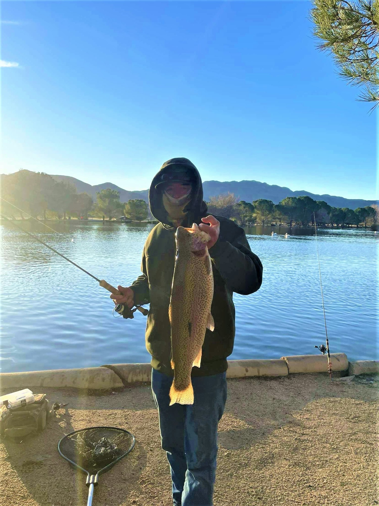 May contain: fishing, outdoors, water, leisure activities, portrait, photography, person, head, face, soil, pants, clothing, waterfront, trout, fish, sea life, animal, scenery, nature, lake, sword, weapon, jacket, and coat