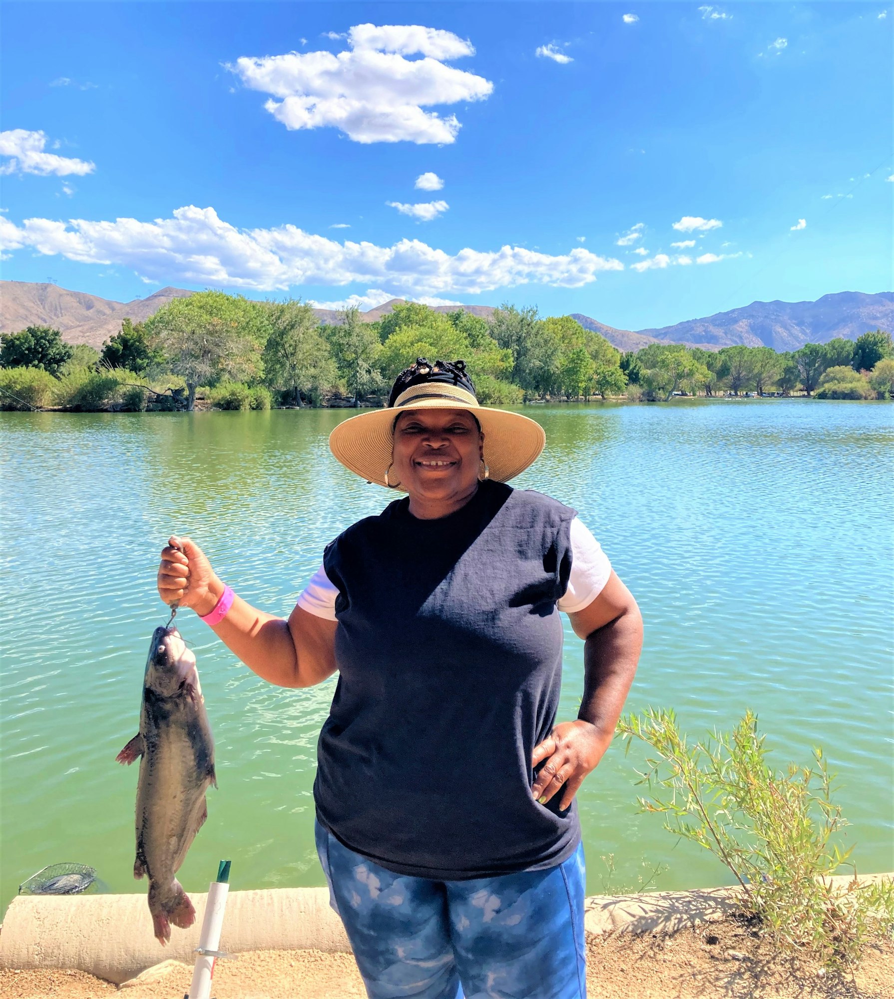 May contain: portrait, photography, person, head, face, scenery, outdoors, nature, fishing, water, leisure activities, fish, sea life, animal, lake, summer, hat, clothing, bracelet, jewelry, accessories, vegetation, plant, waterfront, trout, and tree