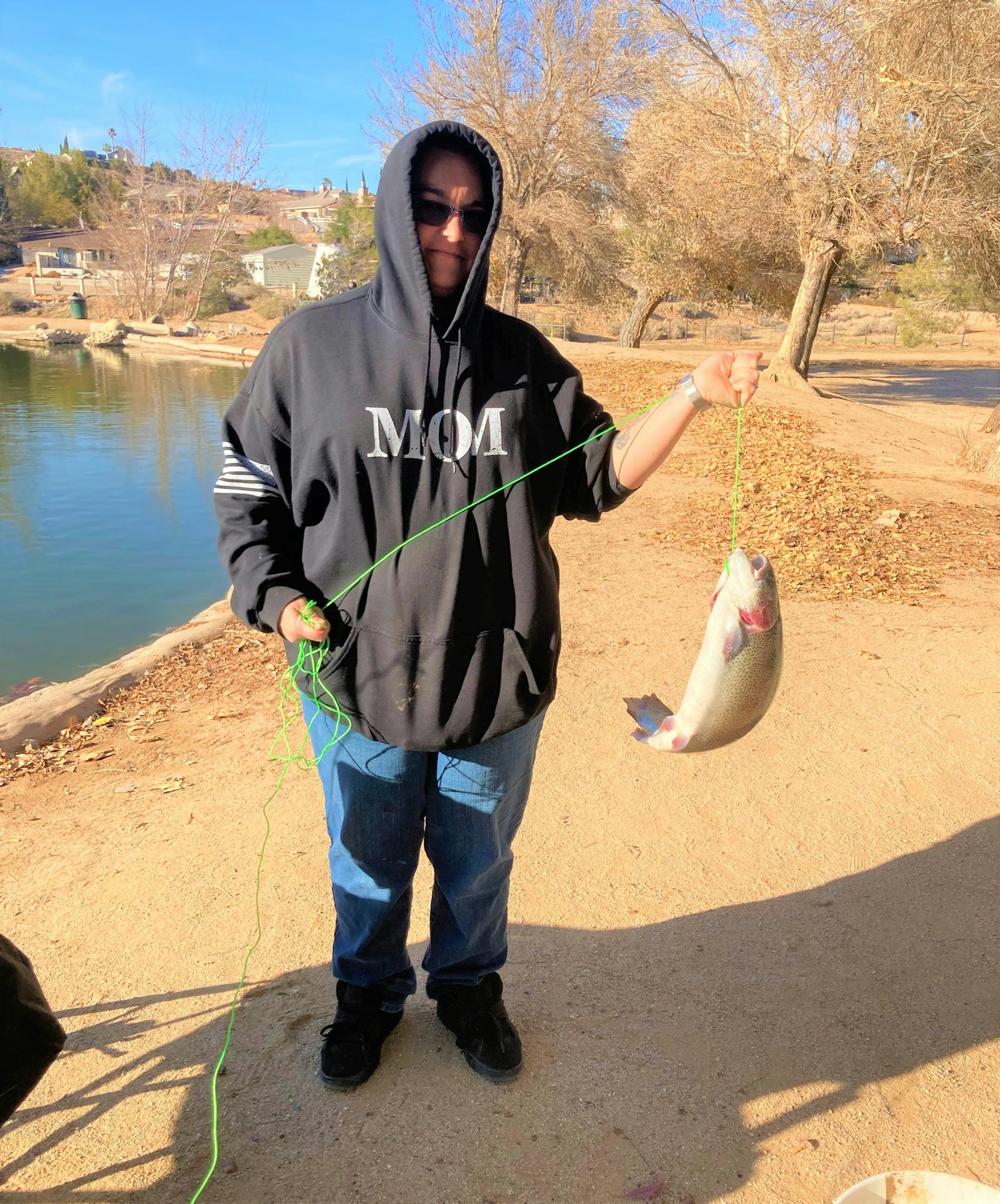 May contain: portrait, photography, person, head, face, fishing, outdoors, water, leisure activities, pants, clothing, hoodie, sweatshirt, sweater, knitwear, rock, soil, shoe, footwear, angler, and jeans