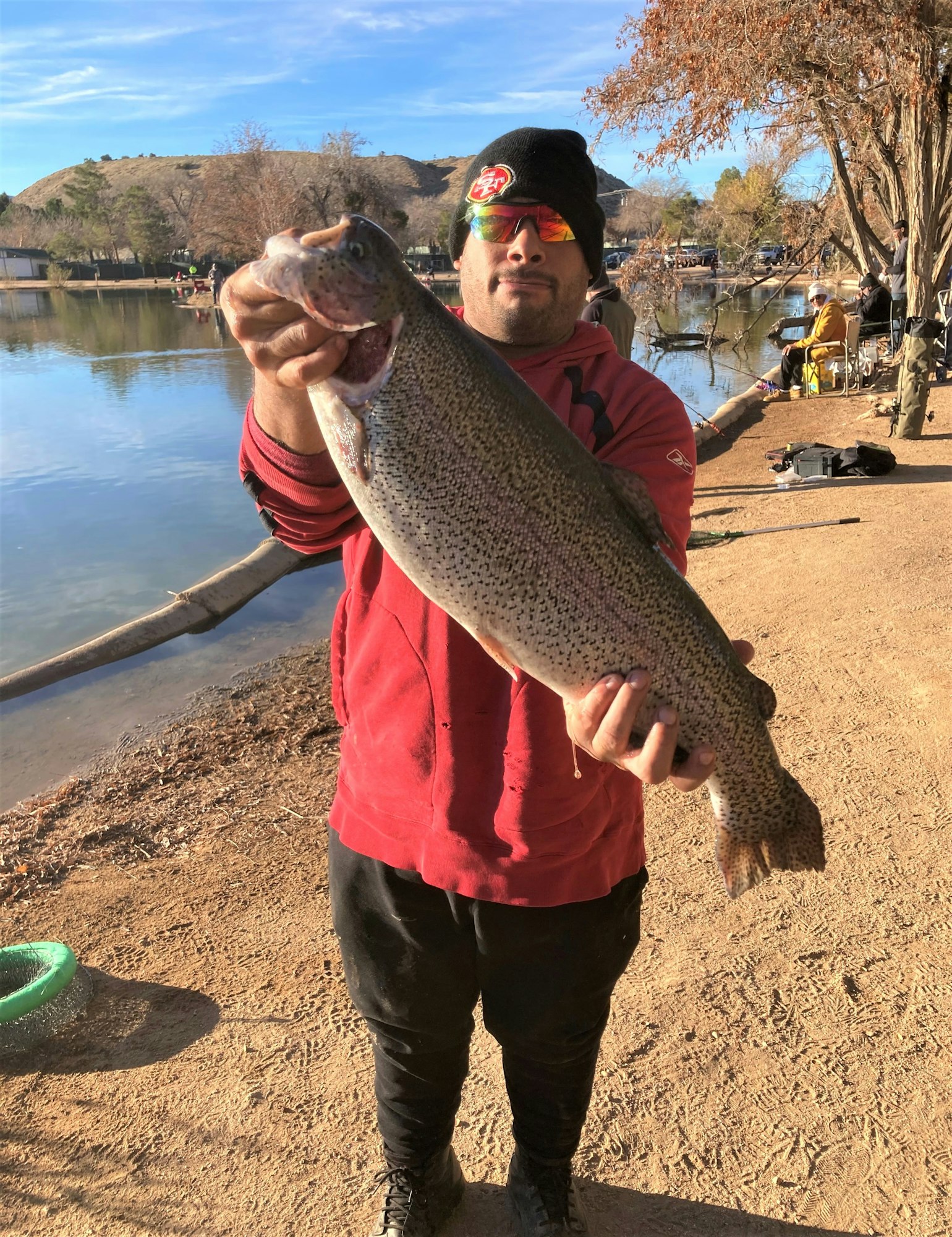 May contain: portrait, photography, person, head, face, soil, fish, sea life, animal, trout, glasses, accessories, hat, clothing, tree, plant, outdoors, fishing, water, leisure activities, car, vehicle, and transportation