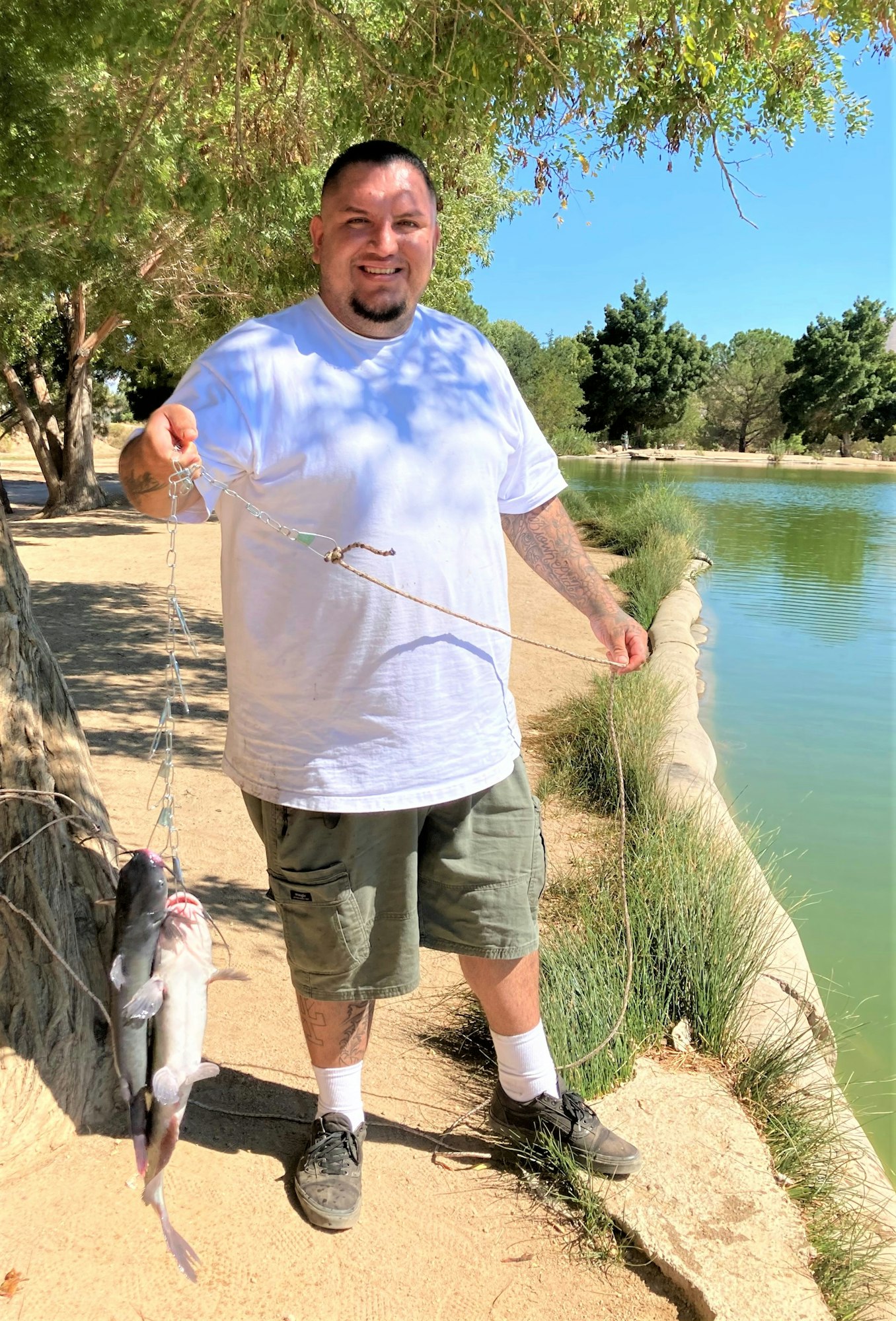 May contain: outdoors, water, person, human, clothing, apparel, and shorts
